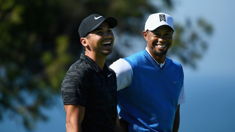 Jason Day of Australia and Tiger Woods share a laugh on the fourth hole during the first round of the Farmers Insurance Open 