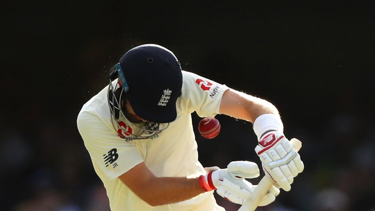 BRISBANE, AUSTRALIA - NOVEMBER 25:  Joe Root of England is struck in the helmet by a delivery from Mitchell Starc of Australia during day three of the Firs