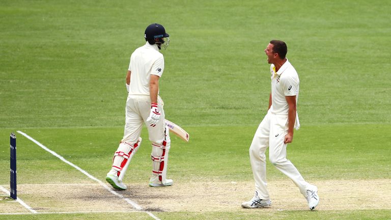 Joe Root of England looks dejected as Josh Hazlewood of Australia celebrates taking his wicket during day four