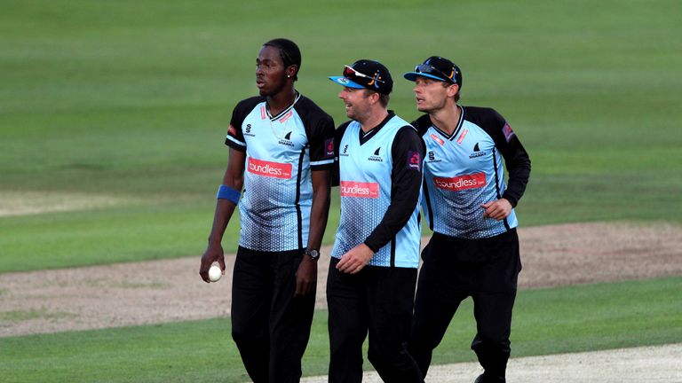 CANTERBURY, ENGLAND - AUGUST 04: Jofra Archer (L) of Sussex Sharks is congratulated by teammates captain Chris Nash (C) and Danny Briggs (R) after taking t