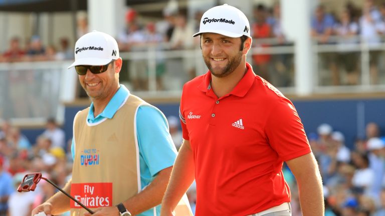 DUBAI, UNITED ARAB EMIRATES - NOVEMBER 19:  Jon Rahm of Spain reacts on the 18th green with his caddie Adam Hayes during the final round of the DP World To