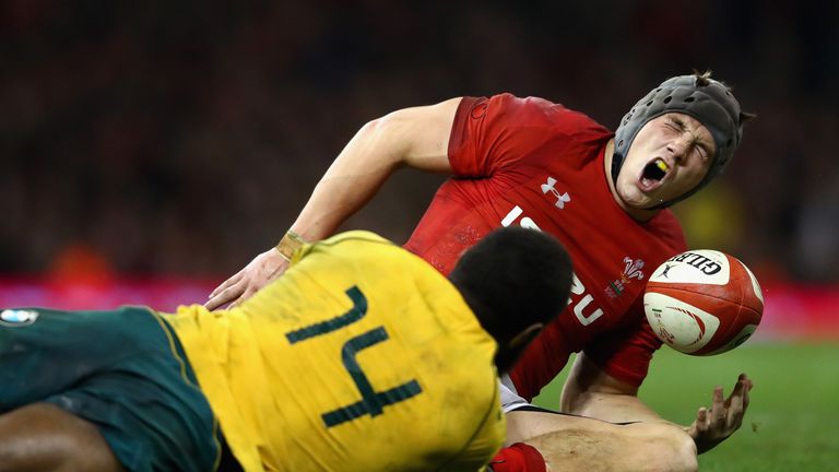 CARDIFF, WALES - NOVEMBER 11: Jonathan Davies of Wales reacts to being tackled by Marika Koroibete of Australia and is later stretched off injured during t