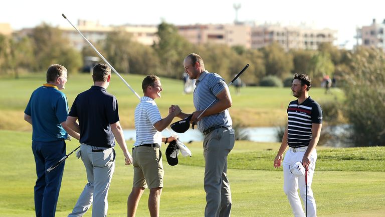 TARRAGONA, SPAIN - NOVEMBER 16:  Jonathan Thomson of England celebrates with his caddie after earning his card during the final round of the European Tour 
