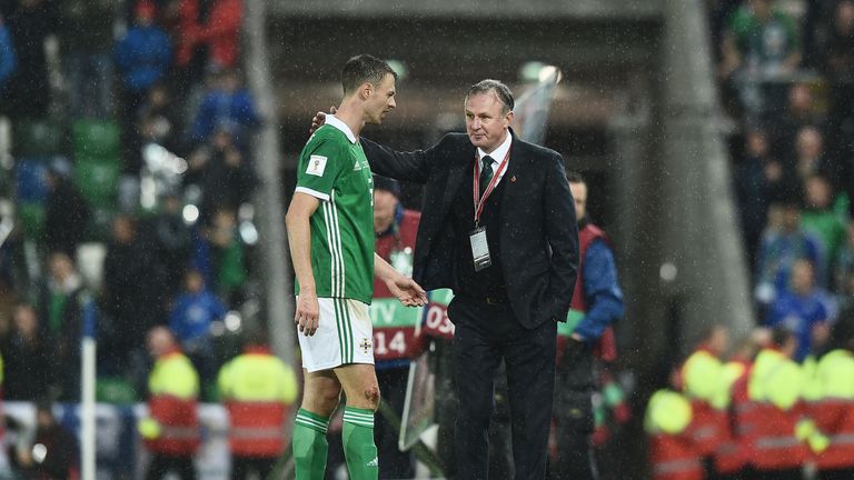 Northern Ireland manager Michael O'Neill consoles Jonny Evans after defeat to Switzerland