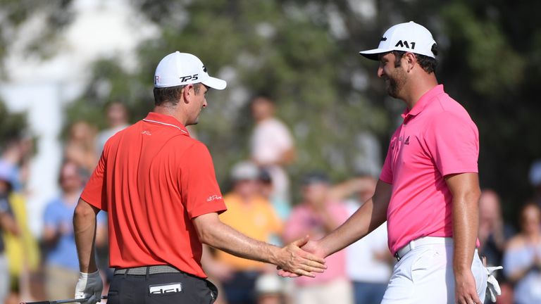 DUBAI, UNITED ARAB EMIRATES - NOVEMBER 18:  Justin Rose of England is congratulated by Jon Rahm of Spain after his birdie on the 13th green during the thir