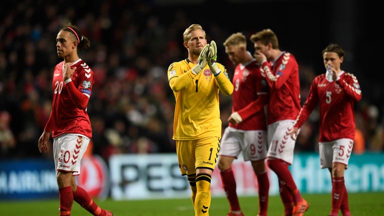 Yussuf Poulsen (L) and goalkeeper Kasper Schmeichel (C) of Denmark react after the play-off FIFA World Cup 2018 qualification football match of Denmark vs 