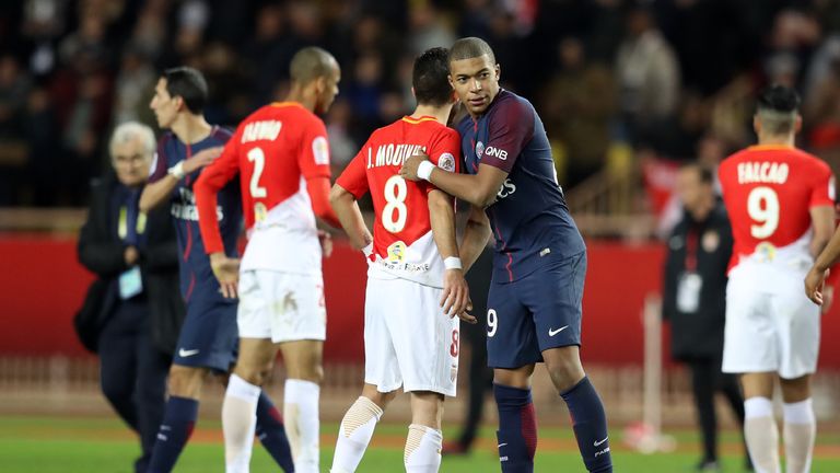 Paris Saint-Germain's French forward Kylian Mbappe (R) congratulates Monaco's Portuguese midfielder Joao Moutinho (L) at the end of the French L1 football 