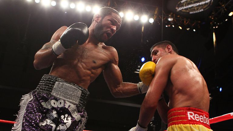 Lamont Peterson punches Amir Khan during their WBA Super Lightweight and IBF Junior Welterweight title fight in Washington.