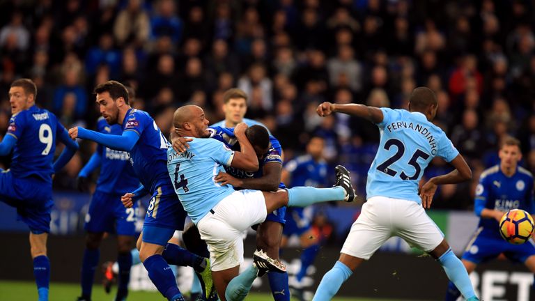 Manchester City's Vincent Kompany and Leicester City's Wes Morgan grapple during the Premier League match at the King Power Stadium