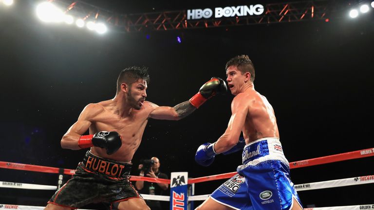 INGLEWOOD, CA - SEPTEMBER 23:  Jorge Linares of Venezuela (black shorts) exchanges punches with Luke Campbell of Great  Britain (blue shorts) during their 