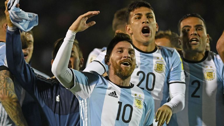 Argentina's Lionel Messi (C) celebrates after defeating Ecuador and qualifying to the 2018 World Cup football tournament, in Quito, on October 10, 2017. / 