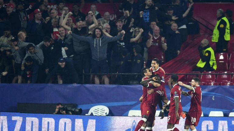 Liverpool players celebrate in front of their own fans after taking a 3-0 lead in Seville