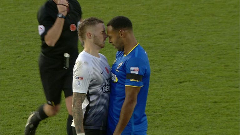 Marcus Maddison and Liam Trotter go head to head during the League One game between Wimbledon and Peterborough.