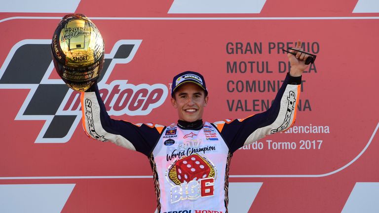 Marc Marquez celebrates on the podium after claiming another MotoGP title
