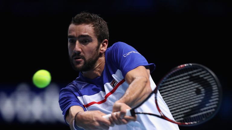 Marin Cilic of Croatia plays a backhand in his match against Alexander Zverev of Germany during day one of the Nitto ATP Finals