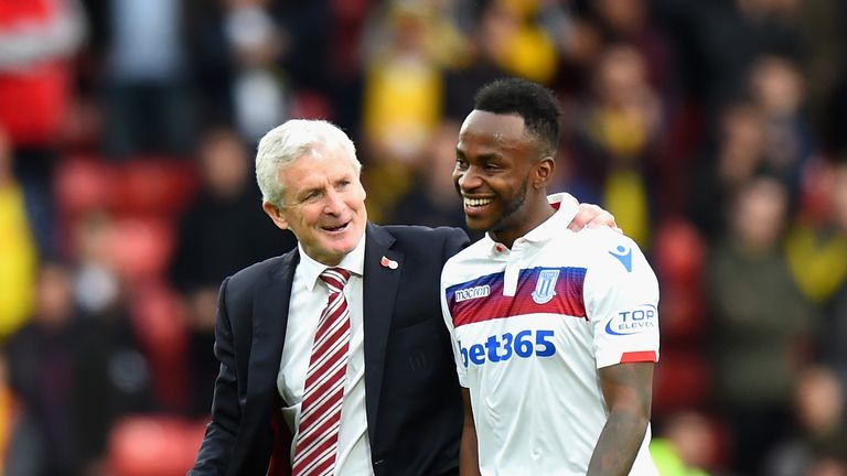 Mark Hughes, Manager of Stoke City and Saido Berahino of Stoke City embrace after the Premier League match between Watford and Stoke