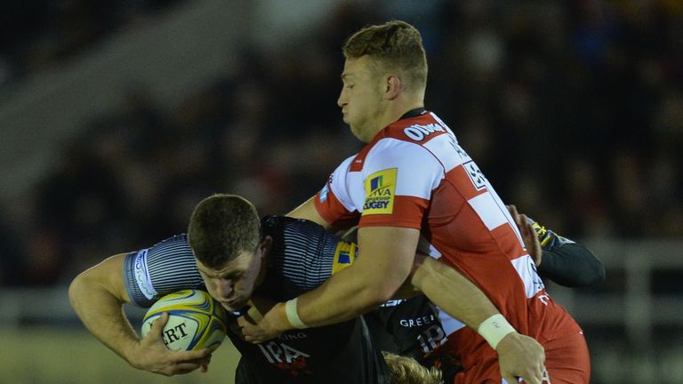 Mark Wilson of Newcastle Falcons is tackled by Gloucester's Ruan Ackermann