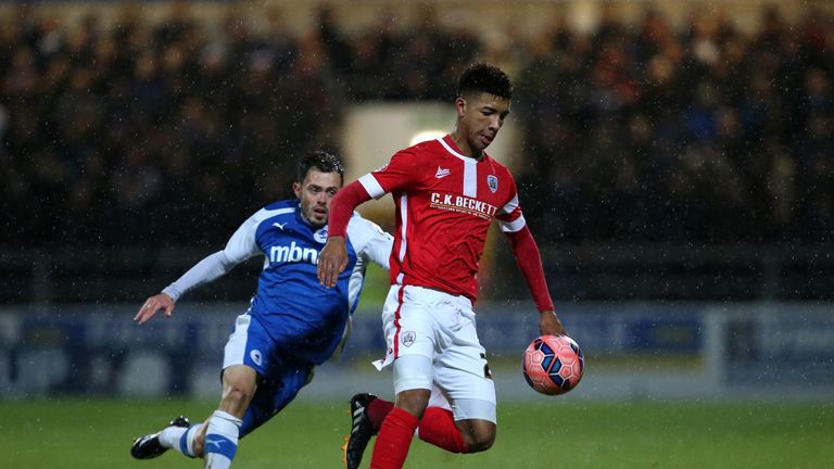 CHESTER, ENGLAND - DECEMBER 16:  Mason Holgate of Barnsley clears the ball from Craig Mahon of Chester during the FA Cup Second Round Replay match between 