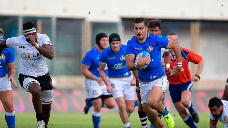 Italy's winger Mattia Bellini (R) runs the ball during a rugby union test match between Italy and Fiji at the Angelo Massimino Stadium in Catania on Novemv