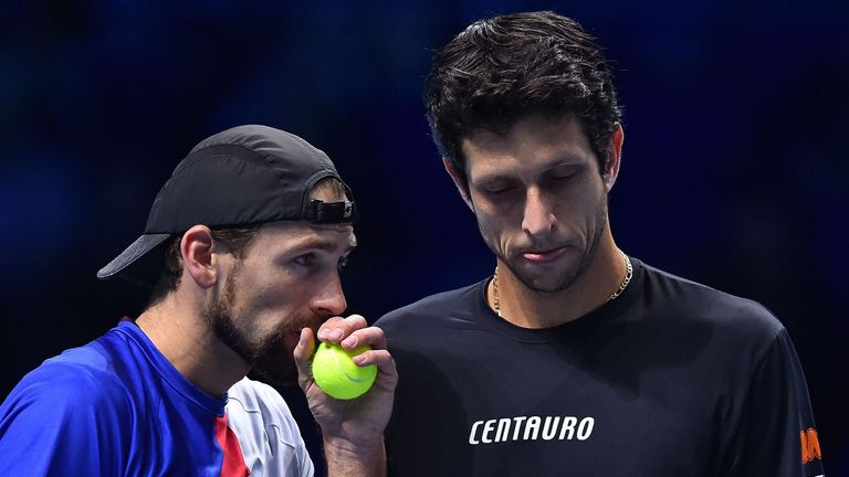 Brazil's Marcelo Melo (R) and Poland's Lukasz Kubot discuss tactics against Finland's Henri Kontinen and Australia's John Peers during their men's doubles 