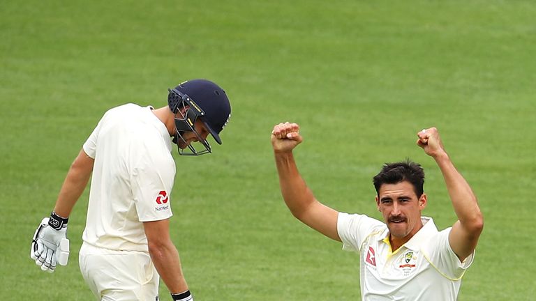Dawid Malan of England looks dejected as Mitchell Starc of Australia celebrates taking his wicket during day two