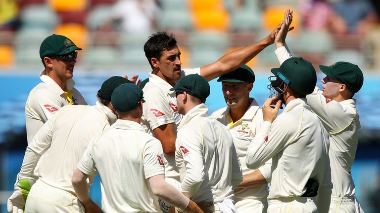 Mitchell Starc of Australia celebrates after taking the wicket of Chris Woakes of England during day four