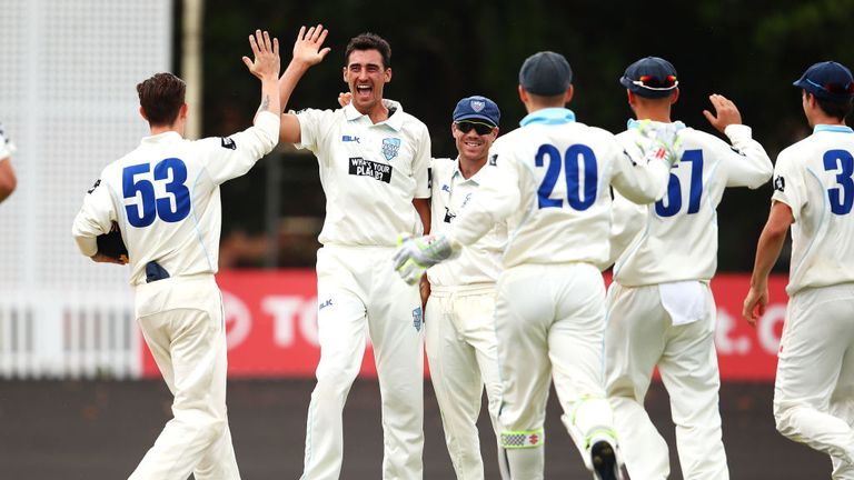 SYDNEY, AUSTRALIA - Nov 6:  Mitchell Starc of the Blues celebrates with his Blues team after bowling Simon Mackin of the Warriors to take a hat-trick v WA