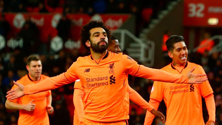 Liverpool's Egyptian midfielder Mohamed Salah (C) celebrates scoring their second goal during the English Premier League football match between Stoke City 
