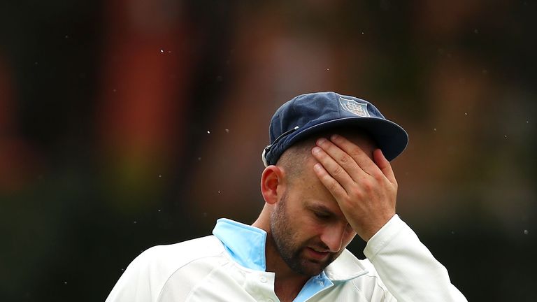 Nathan Lyon of the Blues rubs his head as he fields during day three of the Sheffield Shield match between New South Wales