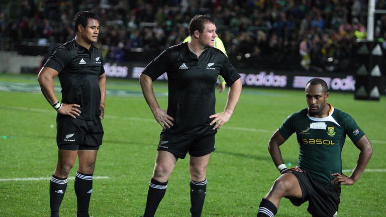 Isaia Toeava (L) and Tony Woodcock (C) of the New Zealand All Blacks watch Josevata Rokocoko of South Africa (R) during their Tri-Nations rugby union match