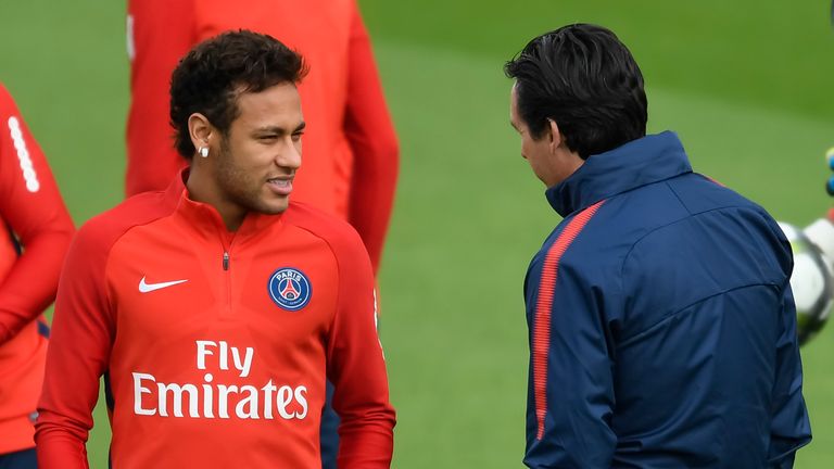 Paris Saint-Germain's Brazilian forward Neymar (L) speaks with Paris Saint-Germain's Spanish head coach Unai Emery during a training session in Saint-Germa