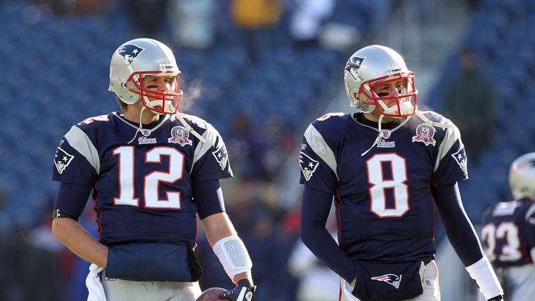 New England Patriots quarterback Tom Brady (R) sits with his