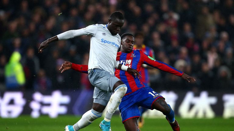 Oumar Niasse is tackled by Jeffrey Schlupp during the contest