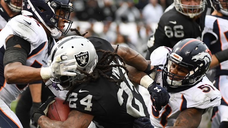 OAKLAND, CA - NOVEMBER 26:  Marshawn Lynch #24 of the Oakland Raiders rushes for a touchdown against the Denver Broncos during their NFL game at Oakland-Al