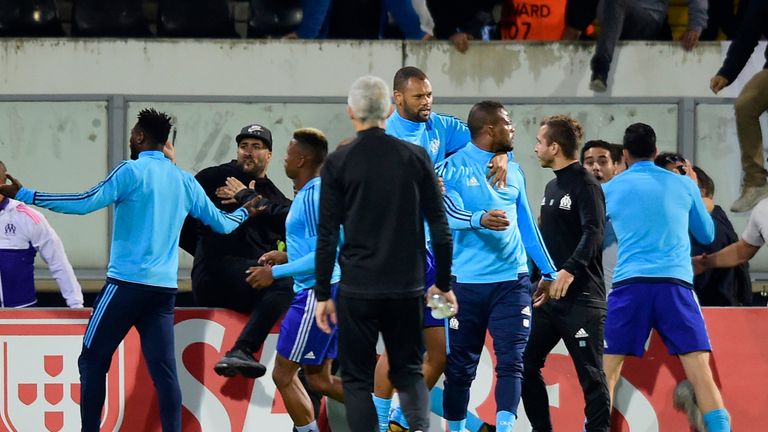 Patrice Evra is ushered away by team-mates after a confrontation with fans during the Europa League tie in Portugal