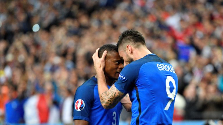 France's forward Olivier Giroud (R) celebrates scoring the opening goal with France's defender Patrice Evra during the Euro 2016 quarter-final football mat