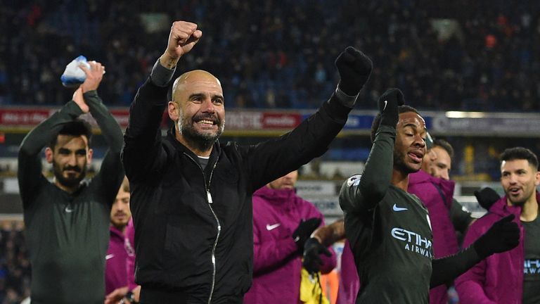 Pep Guardiola celebrates with his players