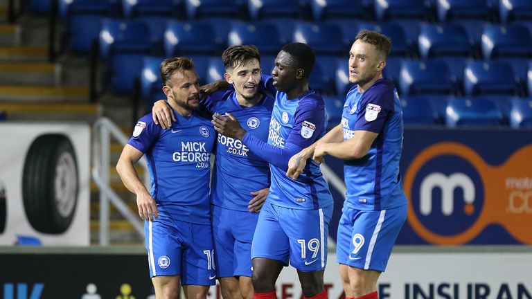 PETERBOROUGH, ENGLAND - OCTOBER 03: Danny Lloyd of Peterborough United celebrates with team mates after scoring his sides first goal during the Checkatrade