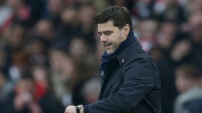 Mauricio Pochettino checks his watch during the north London derby