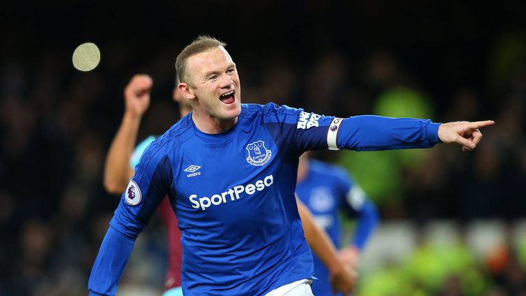 Wayne Rooney celebrates scoring after his first effort was saved