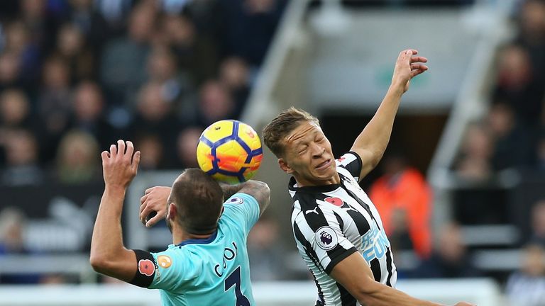 Steve Cook and Dwight Gayle of Newcastle United battle for possession