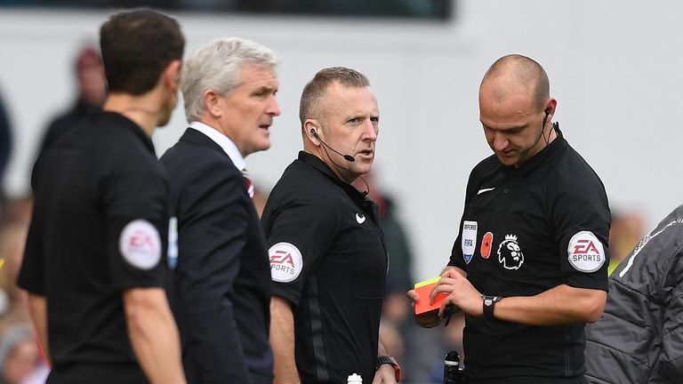 Referee Robert Madley is replaced by fourth official Jon Moss during the first half at the Bet365 Stadium