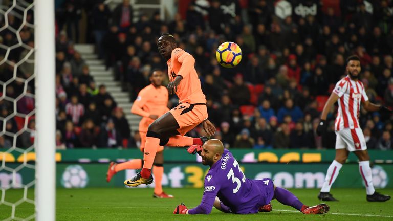 Sadio Mane lifts the ball over Lee Grant to open the scoring at the Bet365 Stadium