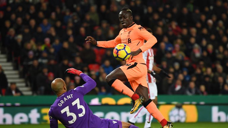 Sadio Mane lifts the ball over Lee Grant to open the scoring at the Bet365 Stadium