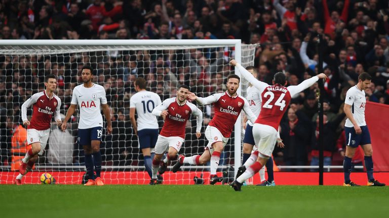 Shkodran Mustafi celebrates with team-mates after scoring the opening goal at the Emirates