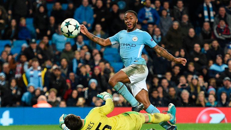 Raheem Sterling (R) lifts the ball over Feyenoord's Brad jones (L) to score City's winner