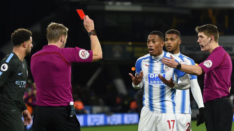 Huddersfield Town's Dutch midfielder Rajiv van La Parra is shown a red card by English referee Craig Pawson at the end of the English Premier League footba