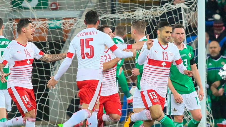 Switzerland's defender Ricardo Rodriguez (2R) celebrates scoring the opening goal from the penalty spot during the FIFA 2018 World Cup qualifier second rou