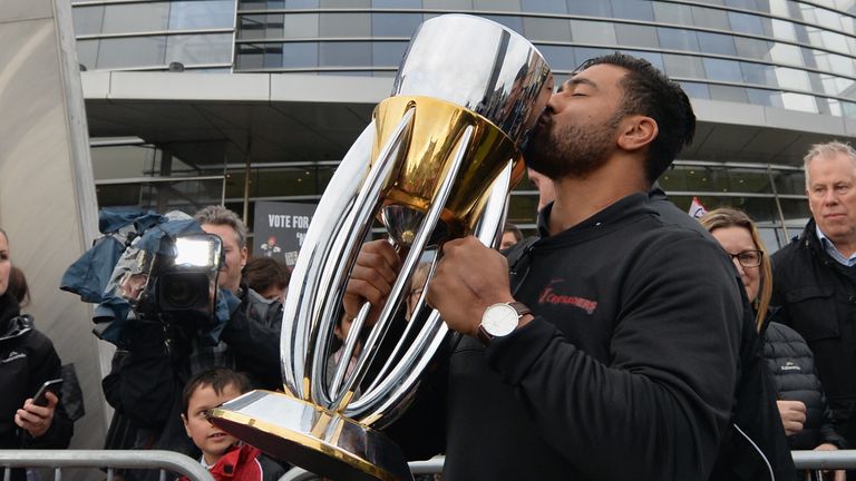 CHRISTCHURCH - AUGUST 08 2017: Richie Mo'unga of the Crusaders kisses the Super Rugby Trophy during a parade at Christchurch Art Gallery