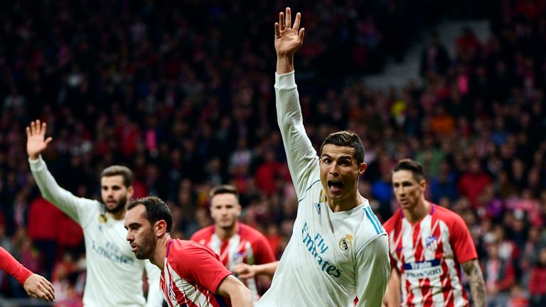 Real Madrid's Portuguese forward Cristiano Ronaldo (2R) gestures during the Spanish league football match Atletico Madrid vs Real Madrid at the Wanda Metro